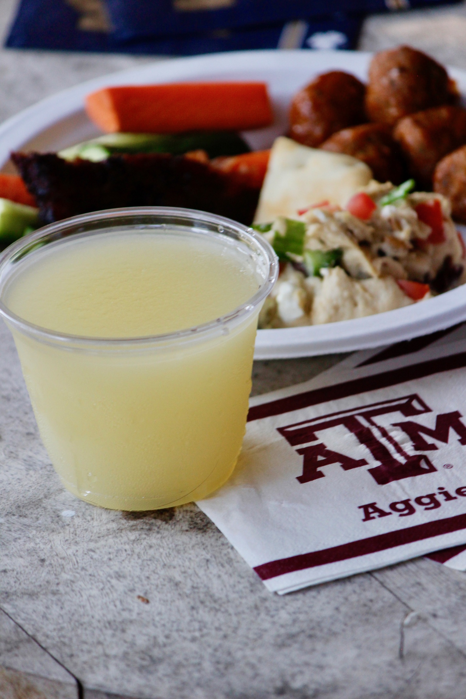 A frozen Doc's slushie on a table with game-day snacks